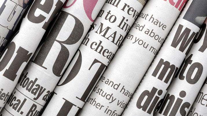 Newspapers stacked together